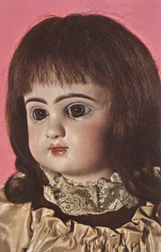 Featured is a postcard image of an antique doll - a 19th century French Fashion Doll made by Pannier.  The doll has paperweight eye, pierced ears, a composition body, and a human hair wig.  The original unused postcard is for sale in The unltd.com Store.